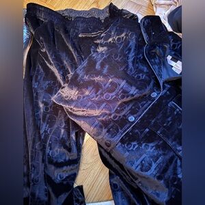 Women printed velour pjs. These are black. Light picks them up as navy